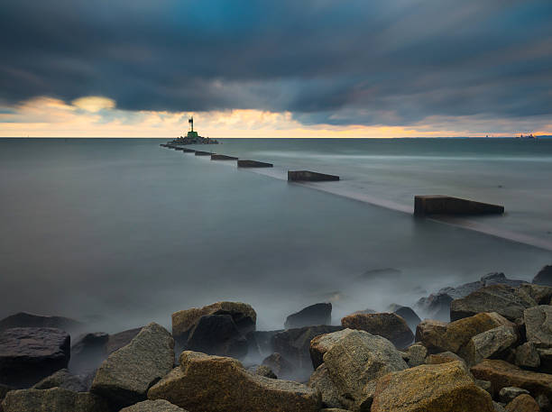 istock Long exposure seascape with stone breakwater 474203134