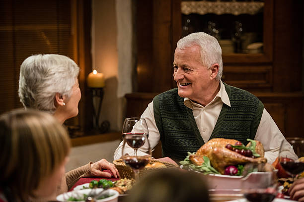 istock Old couple talking at Thanksgiving dinner 474203192
