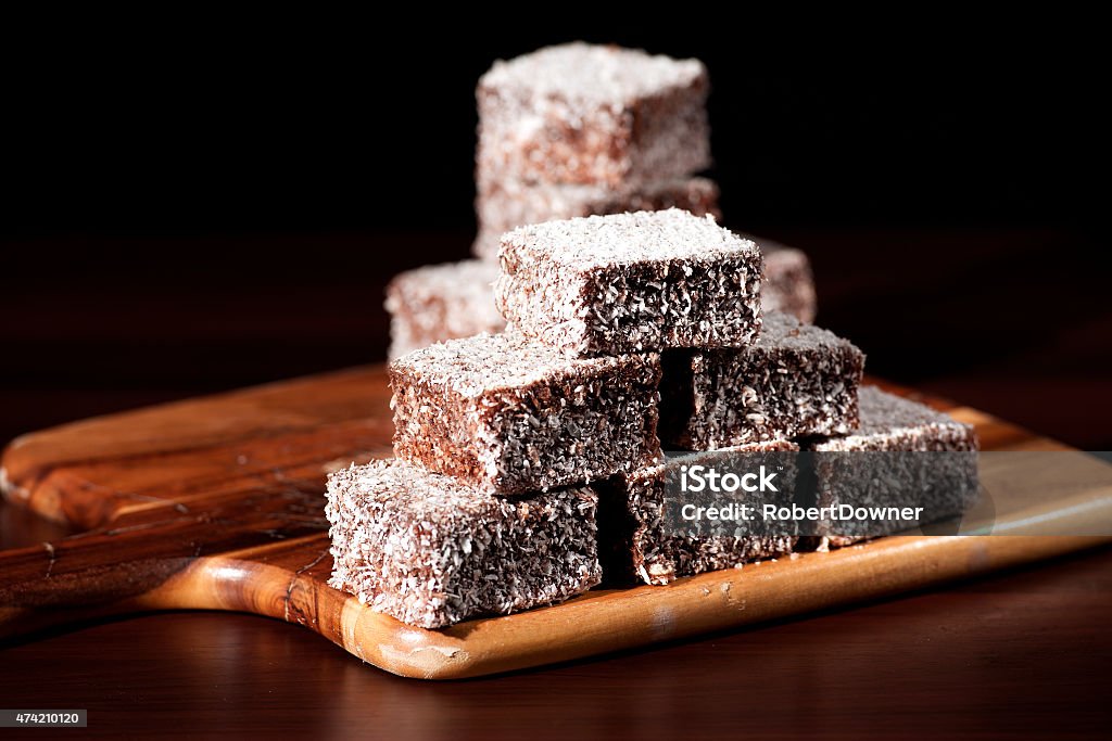 Group of Lamingtons Group of Lamingtons with a dark background. Lamington Cake Stock Photo