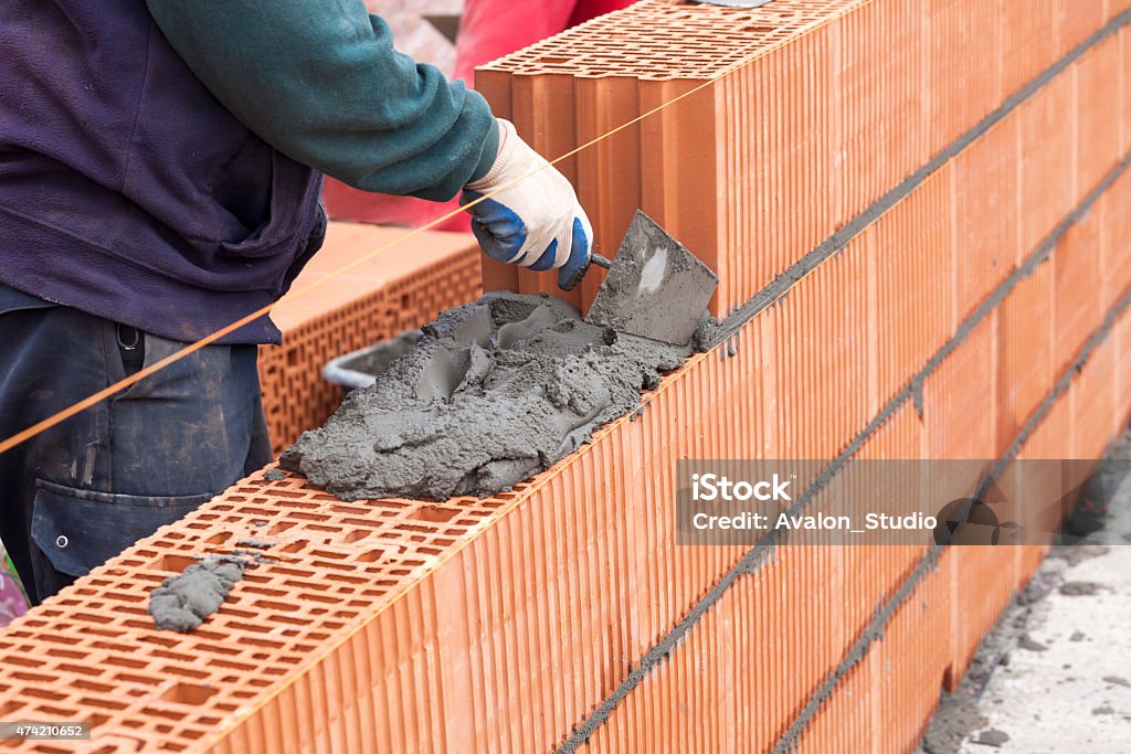 Bricklayer In Work Stock Photo - Download Image Now - 2015, Adult, Blue ...