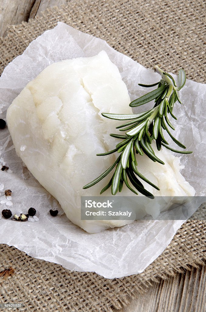cod filled with rosemary on kitchen paper cod filled with rosemary, salt and pepper on kitchen paper Brown Stock Photo