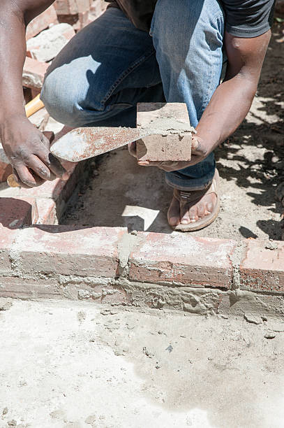 istock African man builds garden wall on a sunny day 474216968