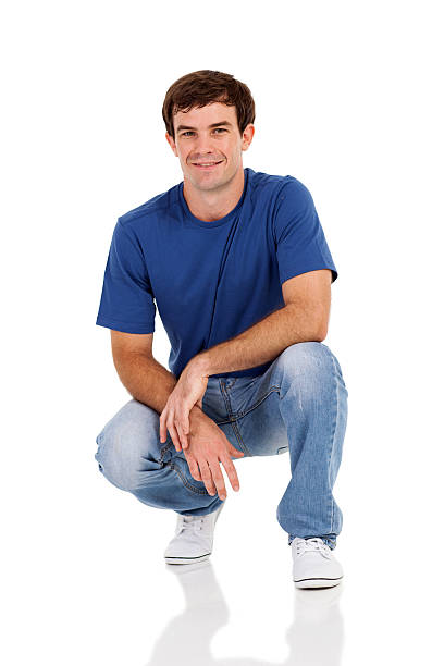 istock casual man squatting on white 474217923