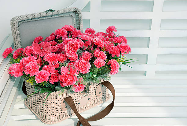 istock pink flowers in basket on wooden table 474218364