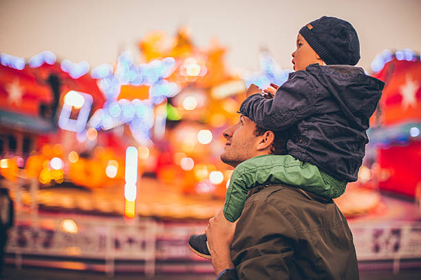 Daddy and me at the amusement park Father and son enjoy together in the amusement park. carnival children stock pictures, royalty-free photos & images