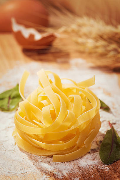 Fresh pasta and chard on wooden table