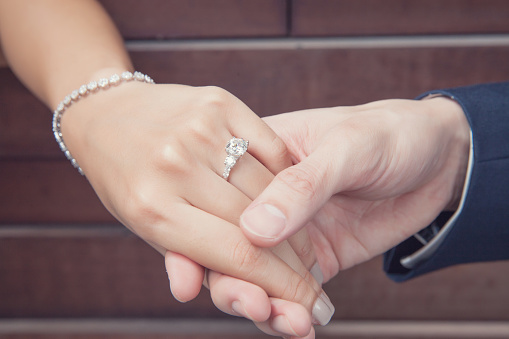 Sosteniendo la mano con anillo de diamante photo