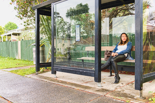 A Brazilian girl in New Zealand at a bus station