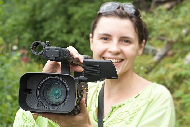 istock Woman with digital video camera. 474222478