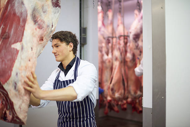 istock young butcher in  meat processing plant 474222788