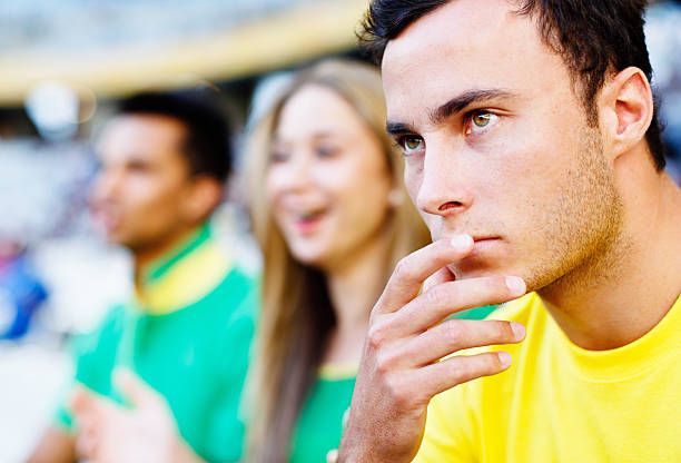istock Handsome football fan looking concerned at match 474223045