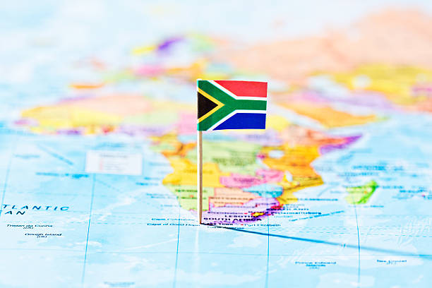 View over oceans of flag marking South Africa Looking over both the Atlantic and Indian Oceans towards a South African flag marking Cape Town  - now one of the world's favorite vacation destinations - on a map of Africa. south africa flag stock pictures, royalty-free photos & images