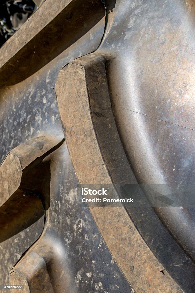 New Tractor Tyre New Tractor Tyre closeup showing the curved tread pattern on the tyre. 2015 Stock Photo