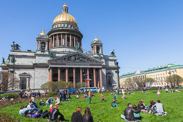 Saint Petersburg, Russia  May 09, 2015:  People relax on the grass in front of St. Isaac's Cathedral in St. Petersburg. Saint Isaac's Cathedral or Isaakievskiy Sobor is the largest Russian Orthodox cathedral