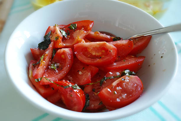istock Sliced Tomatoes inside of White Plate And The Spoon 474228966