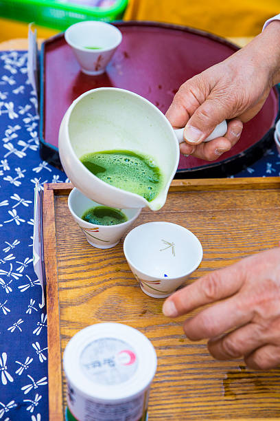 istock hands making traditional matcha (green tea) at market 474230398