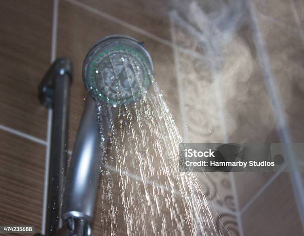 Shower Head With Boiling Water And Steam In The Bathroom Stock Photo - Download Image Now