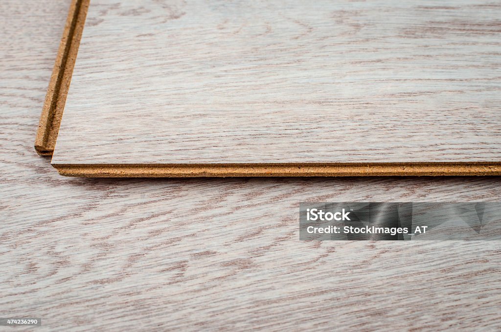 White laminated floor Hardwood floor plank. Newest click system. Photo made in high end photo studio with high quality photo equipment. Also available with black, green and red background. Flooring Stock Photo