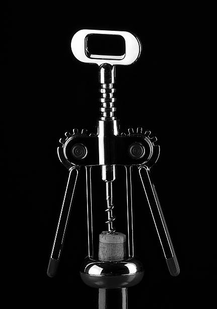 Corkscrew for wine and cork on black background Corkscrew for wine and cork on a white background. Black&white  cork puller stock pictures, royalty-free photos & images