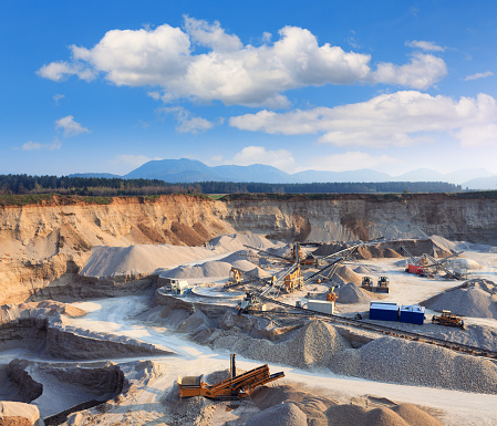 Rock quarry with trucks and all equipment.