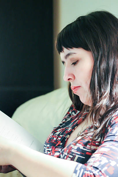 Sad Woman Reads Book in Her Office