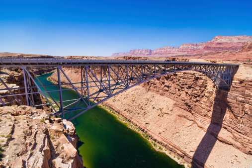 Navajo Bridge crosses the Colorado River's Marble Canyon near Lee's Ferry. Marble Canyon is the section of the Colorado River canyon in northern Arizona from Lee's Ferry to the confluence with the Little Colorado River, which marks the beginning of the Grand Canyon.
