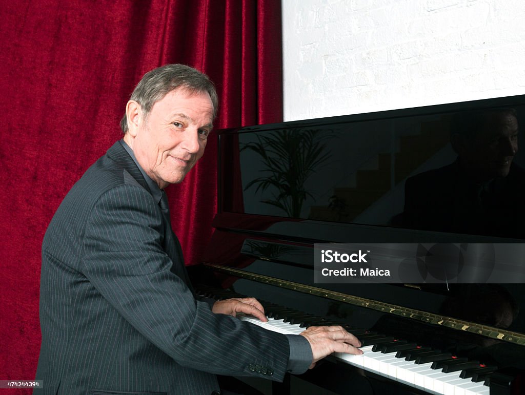 Senior piano man Senior pianist playing piano. Piano Stock Photo