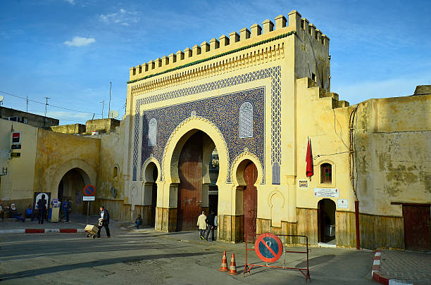 Morocco, Fes Fes, Morocco - November 20th 2014: Unidentified people in front of Bab Boujeloud, entrance to Medina and souk Fes es-Bali bab boujeloud stock pictures, royalty-free photos & images