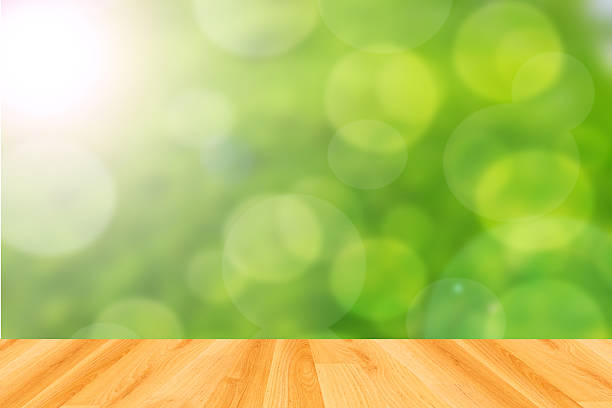 istock wood floor and abstract green bokeh background 474248954