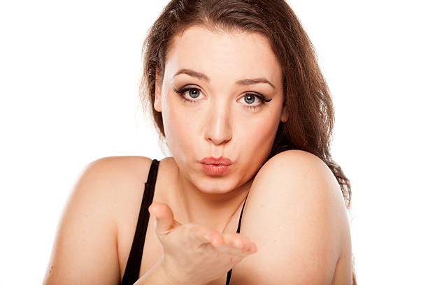 istock woman blowing a kiss 474250106