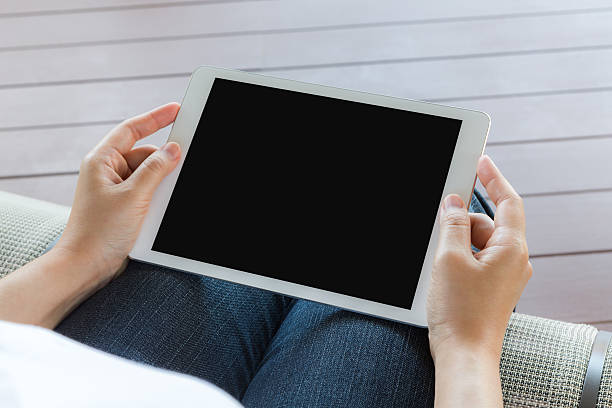 istock Woman hand hold white tablet with blank empty screen 474250152