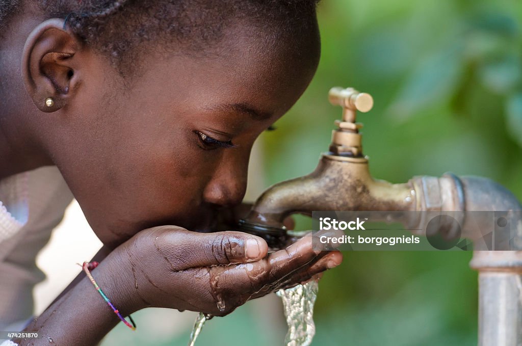 Close-Up of African Child Drinking Water (Drought Water Symbol) Gorgeous African Black Girl Drinking with Hands Cupped (Drought Symbol) Africa Stock Photo