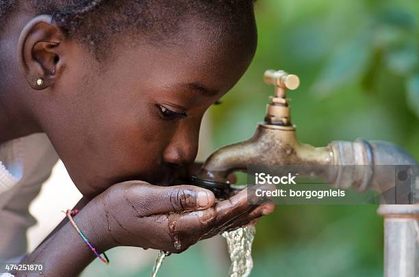 Closeup Of African Child Drinking Water Stock Photo - Download Image Now