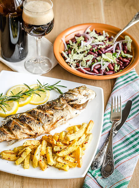 istock Baked seabass with fried potatoes 474257393