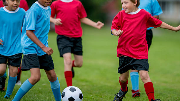 istock Children Chasing a Soccer Ball 474259726