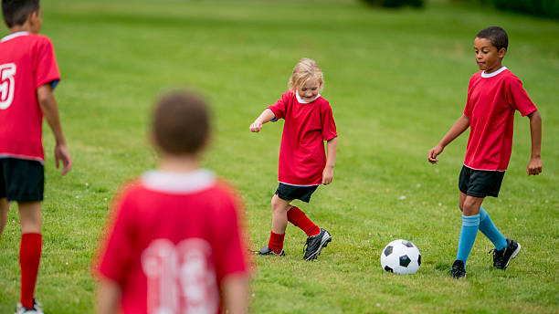 istock Kids Passing a Soccer Ball 474259756