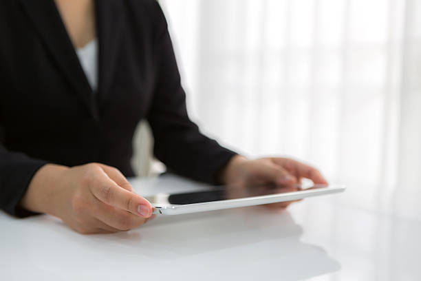 istock Woman hand touch white tablet with blank empty screen 474263002