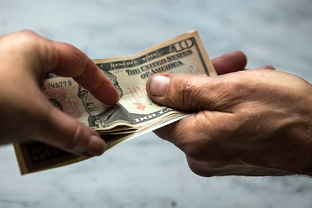 istock Hands giving and receiving money 474263562