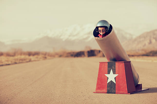 Human Cannonball A young boy is ready to go places, real quick, with the help of a human cannon. Boom. cannon artillery photos stock pictures, royalty-free photos & images