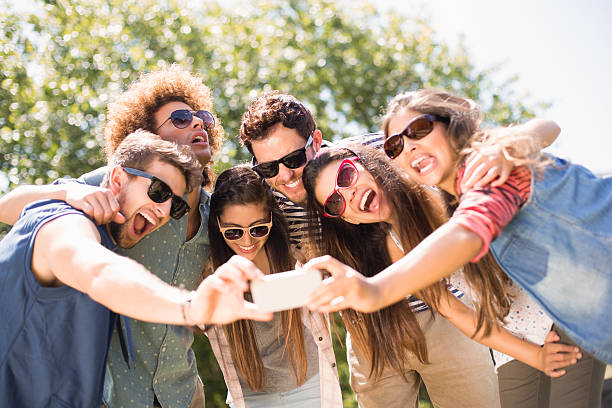 istock Happy friends in the park taking selfie 474264312