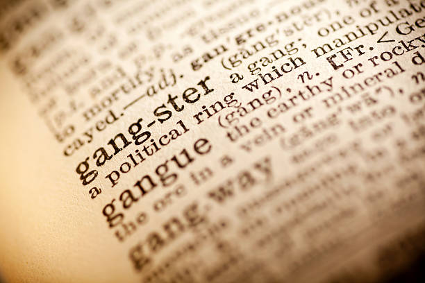 istock Old dictionary open on the word gangster 474265580