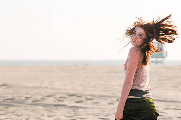 istock Young Redhead woman at beach 474265622