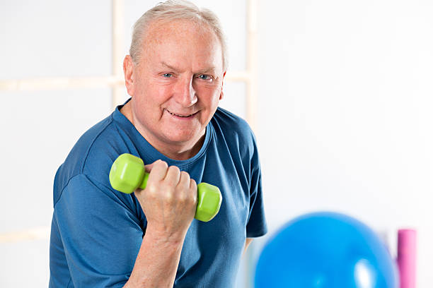 istock Active senior man with weights in gym 474265648