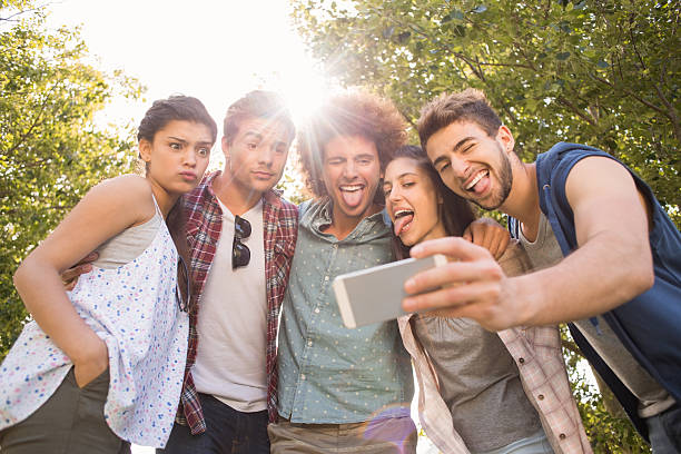 istock Happy friends in the park taking selfie 474266078