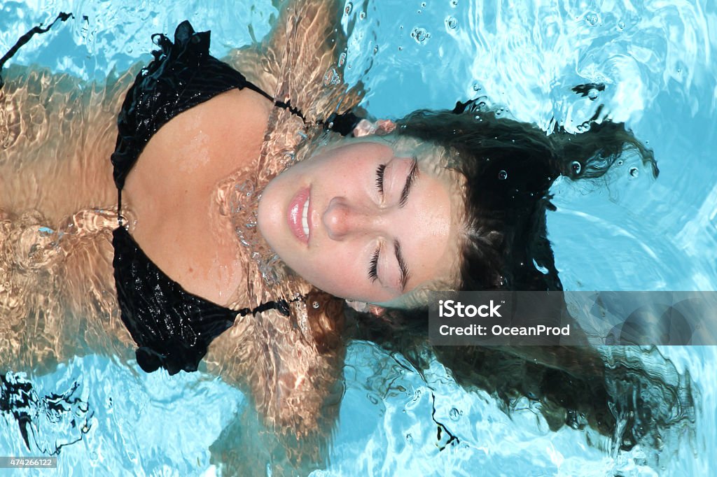 woman relaxing in a swimming pool woman relaxing in a pool 2015 Stock Photo