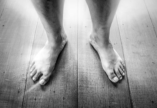 Close up of woman's legs standing in the sea