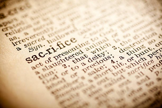 istock Old dictionary open on the word sacrifice 474268188