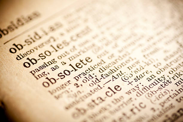 istock Old dictionary open on the word obsolete 474268198