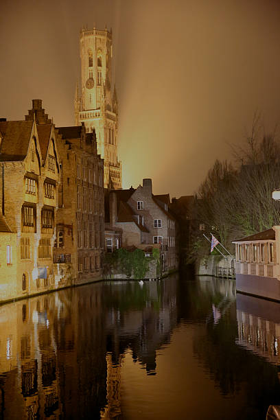 Belfry of Bruges at night Belfry of Bruges, Dijver river and canal houses at night. arma-globalphotos stock pictures, royalty-free photos & images
