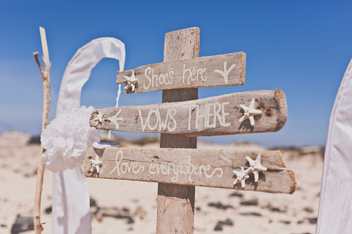 Wooden sign for a beach wedding